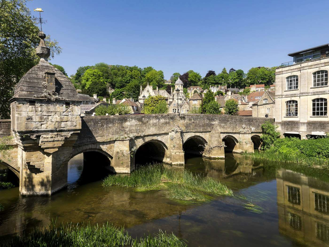 Stone town of Bradford-on-Avon rising above its medieval bridge on the River Avon